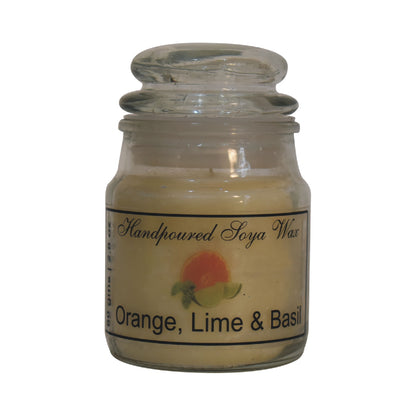 oragne lime and basil scented candle on a white background