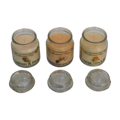 3 scented candles. including lemon & pine, honeysuckle & jasmine, orange lime & basil on a white background